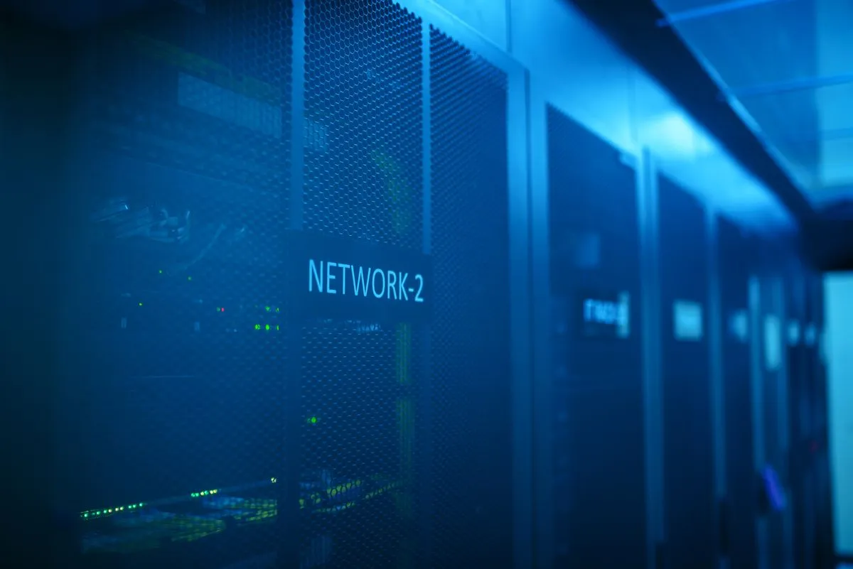 A modern server room lit in blue, with rows of networking equipment